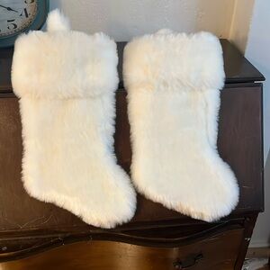 Two white fuzzy Christmas stockings